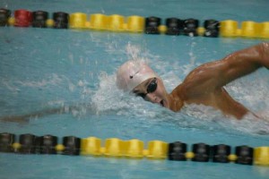 Taking a breath, junior Noah Reid swims freestyle. He has been swimming since he was nine. "It gives me a lot of life traits, like haw to manage my time. Hard work definitely pays off," Reed said. 