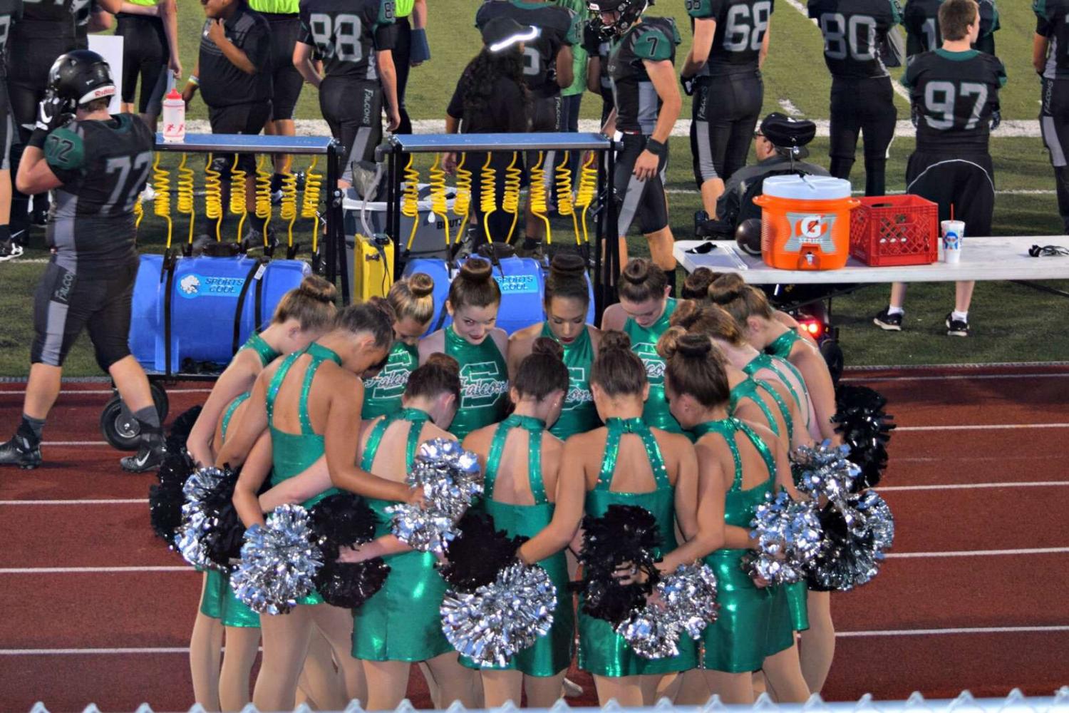 The+Emeralds+are+praying+before+performing+at+the+home+football+game+against+North+Kansas+City+on+Aug.+25.+Each+person+in+the+group+puts+a+foot+in+the+middle+to+clear+their+minds+and+pray.+%E2%80%9CIt%E2%80%99s+our+make+it+or+break+it+moment.+It%E2%80%99s+the+moment+where+we+unite+as+a+team+so+we+can+execute+our+dance+successfully+on+the+field%2C%E2%80%9D+said+sophomore+Grace+Siegfried.