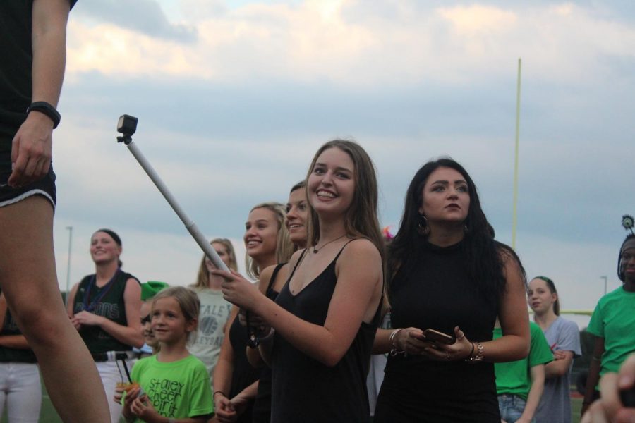 Filming+for+her+next+hype+video+at+the+pep+rally+on+Sept.+20%2C+junior+Pierson+Beaulieu+records+the+students+yelling+a+chant.++She++normally+recorded+the+student+section%2C+cheerleaders%2C+Emeralds+and+players+during+games.+%E2%80%9CI+hope+to+make+more+videos+for+other+sports%2C%E2%80%9D+said+Beaulieu.