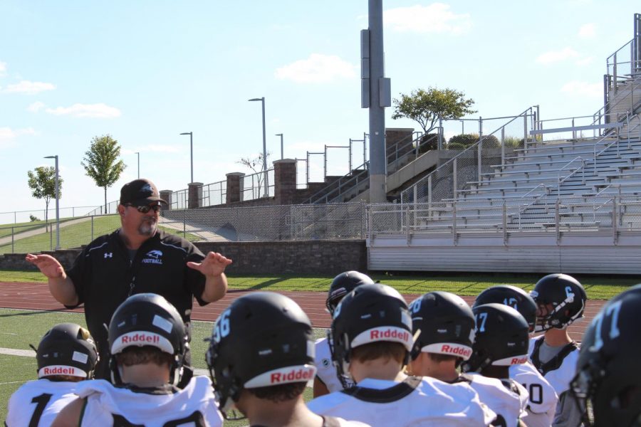 On+Sept.+28%2C+head+coach+Phil+Lite+gives+the+team+a+post-practice+talk.+It+was+the+day+before+a+game%2C+and+the+players+had+just+gotten+done+with+walk+throughs.+%E2%80%9CHe%E2%80%99s+a+good+speaker%2C+and+he+just+gets+us+ready+to+play.+He%E2%80%99s+a+coach+on+the+field+but+like+a+friend+off+the+field%2C%E2%80%9D+said+varsity+quarterback+senior+John+Raybourn.+Photo+by+Leidy+Venegas
