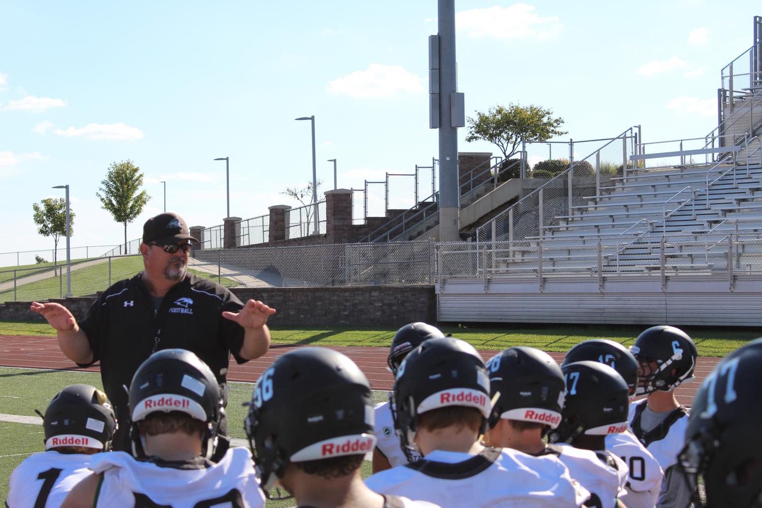 On Sept. 28, head coach Phil Lite gives the team a post-practice talk. It was the day before a game, and the players had just gotten done with walk throughs. “He’s a good speaker, and he just gets us ready to play. He’s a coach on the field but like a friend off the field,” said varsity quarterback senior John Raybourn. Photo by Leidy Venegas